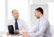 © Syda Productions - two smiling businessmen with laptop in office