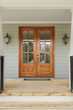 Twin wooden doors to a green family home