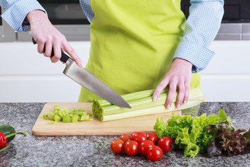 Wall Mural - Housewife cut leek on the board