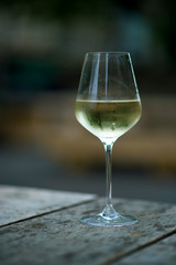 Wall Mural - color image of chilled white wine in a glass , with copy space