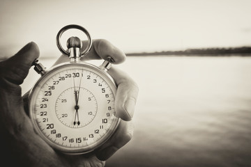 Old chronometer in man hand, vintage  style