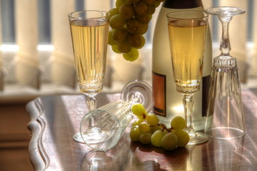 Champagne, glasses and grapes.