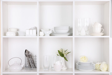 Canvas Print - Different white clean dishes on wooden shelves