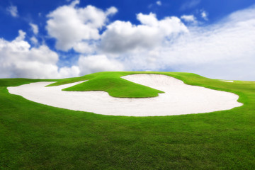 Sand bunkers on the golf course with blue sky