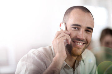 Wall Mural - Cheerful salesman talking on the phone