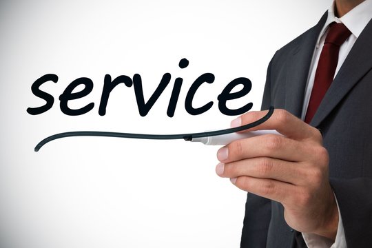 Businessman writing the word service