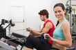 © WavebreakmediaMicro - Smiling brunette working out on the rowing machine
