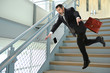 Senior Businessman Falling on Stairs