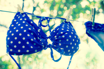 Retro toned polka dot bikini on clothesline