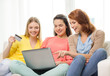 © Syda Productions - smiling teenage girls with laptop and credit card