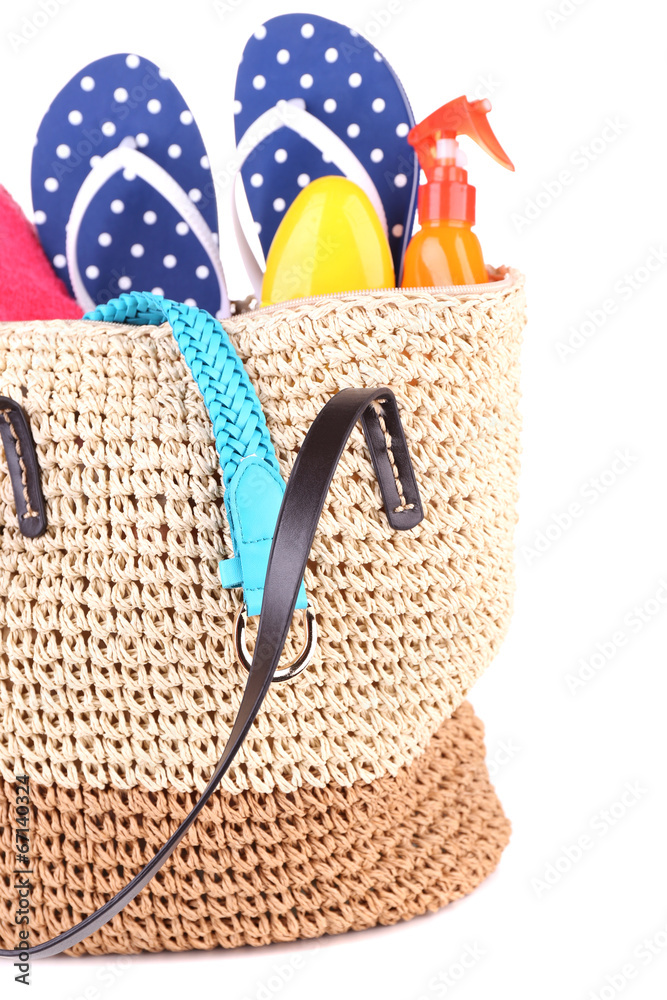 Summer wicker bag with accessories, isolated on white