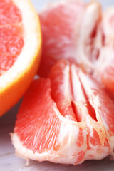 Wall Mural - Ripe grapefruits on cutting board, on wooden background