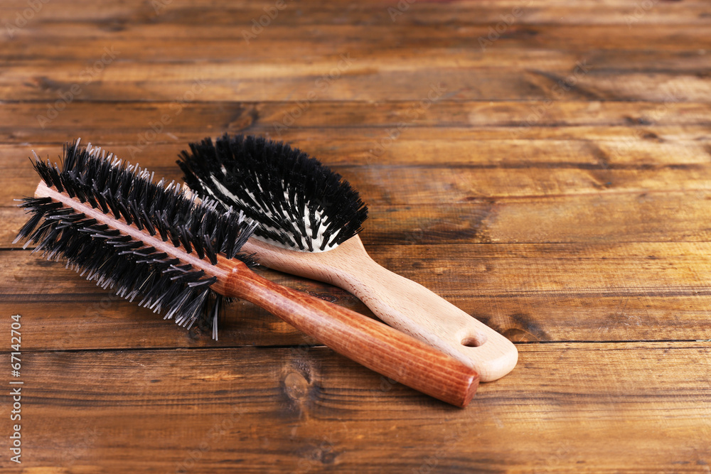 Wooden hairbrushes on wooden background