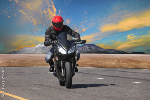 Naklejka na szybę young man riding motorcycle in asphalt road curve use for extrem