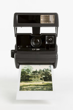 Old-fashioned Instant Camera With Finished Photoshot
