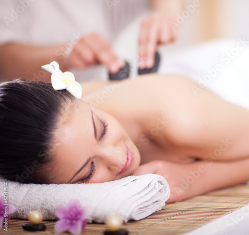 Pinturas sobre lienzo Beautiful woman having a wellness back massage with hot stones