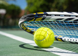 Close up view of tennis racket and balls on  tennis court