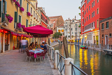 Narrow Canal Among Old Colorful Brick Houses In Venice