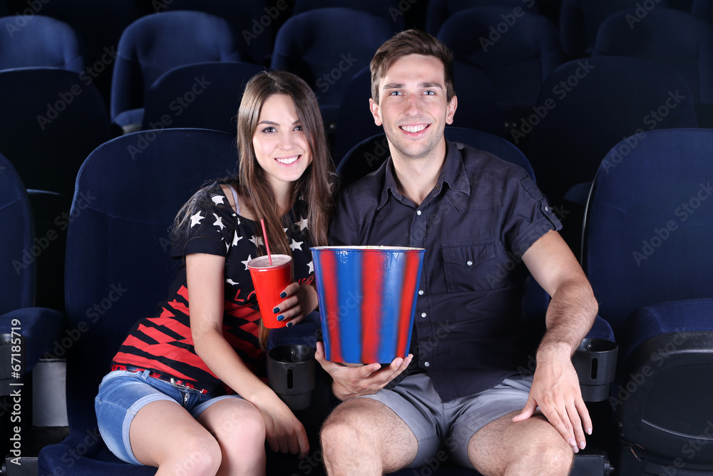 Young couple watching movie in cinema