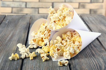 Popcorn on wooden table, close up