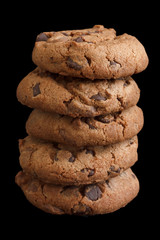 Wall Mural - Stack of chocolate chip cookies isolated on black.