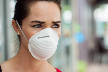 Woman wearing mask in city.