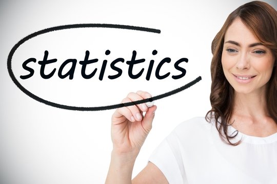 Businesswoman writing the word statistics