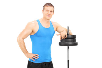 Poster - Muscular man leaning on a barbell