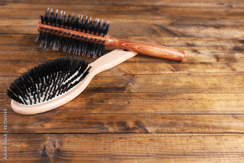 Wooden hairbrushes on wooden background