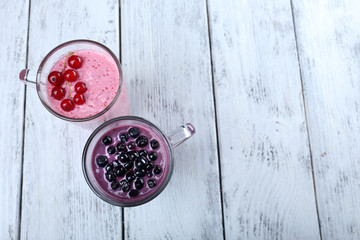 Wall Mural - Delicious berry smoothie on table, close-up