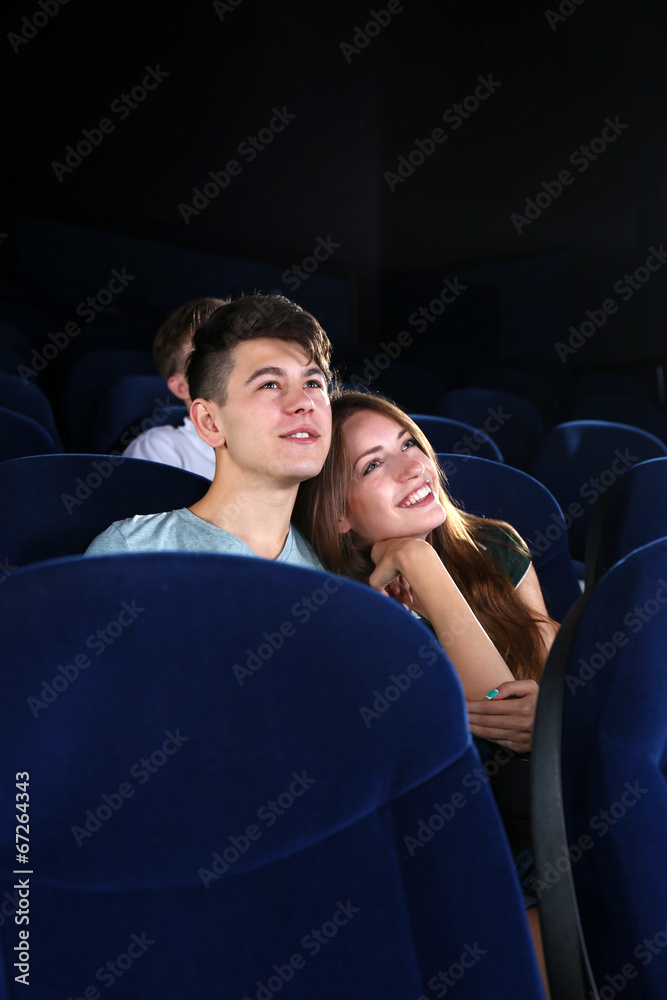 Young couple watching movie in cinema