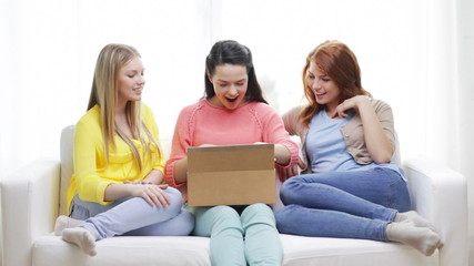 Poster - smiling teenage girls opening cardboard box