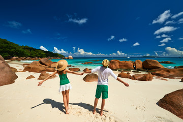 Wall Mural - Couple in green on a beach at Seychelles