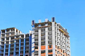 Building construction site work against blue sky