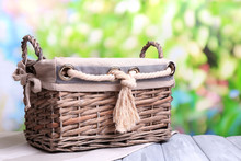 Empty Wicker Basket On Wooden Table, On Bright Background