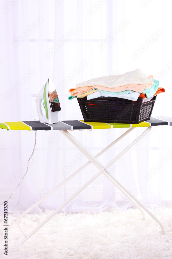 Basket with laundry and ironing board