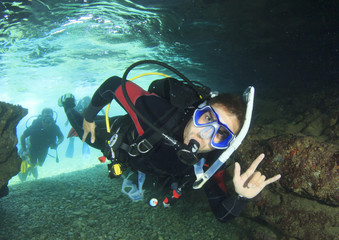 Wall Mural - Scuba diver enters underwater cave