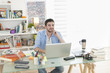 © jackfrog - young student works on his laptop at home