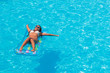 © Netfalls - A girl is relaxing in a swimming pool