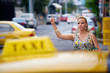 © Diego Cervo - people travelling-business woman stopping yellow taxi