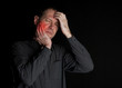 © belinka - Man with a sick tooth keeps cheek hand. On a black background