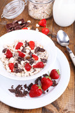 Fototapeta Tulipany - Healthy cereal in bowl with strawberries and chocolate