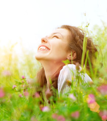 Wall Mural - beautiful young woman outdoors enjoying nature