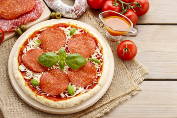 Wall Mural - Italian cuisine: pizza with salami