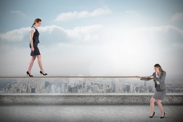 Aufkleber - Young business woman pulling a tightrope for businesswoman