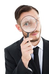 Poster - Geeky businessman looking through magnifying glass