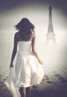 © XtravaganT - Mysterious woman walking towards the Eiffel Tower