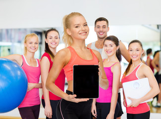 Poster - smiling woman showing tablet pc blank screen