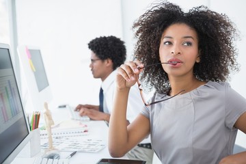 Wall Mural - Young editor thinking at her desk