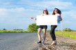 © adam121 - Two young women stand with a blank banner